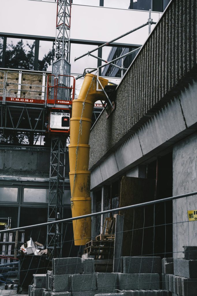 View of a construction site with scaffolding and concrete materials.